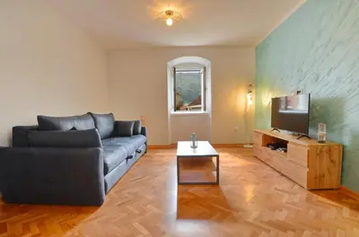 a living room with a couch and a tv at MD Residence in Kotor