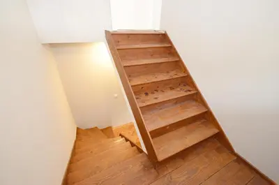 a wooden stair case in a room with wooden floors at MD Residence in Kotor