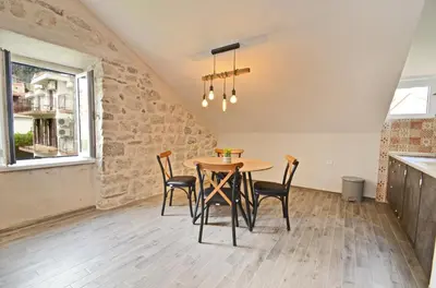 a dining room with a table and chairs at MD Residence in Kotor
