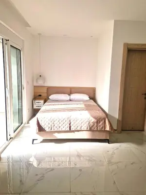 a bedroom with a bed and a large window at IVANA Apartments in Ulcinj