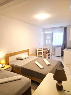 a hotel room with two beds and a dining room at IVANA Apartments in Ulcinj