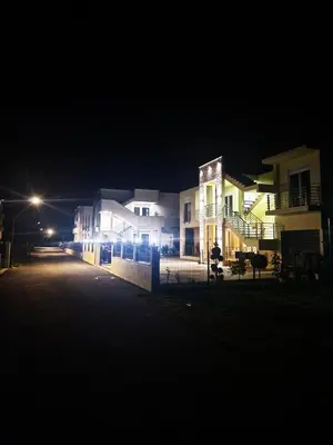 a group of buildings at night with a street at IVANA Apartments in Ulcinj