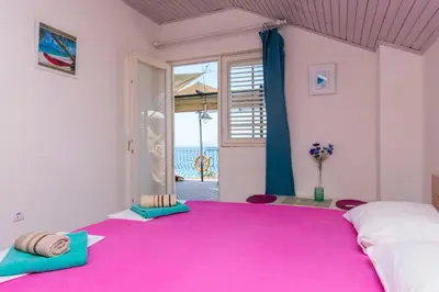 a bedroom with a large pink rug on the floor at Apartment Carpe Diem with the best sea view, Utjeha Montenegro Mediterranean Eu in Masline