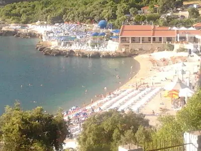 a beach with a bunch of people on the water at Apartment Carpe Diem with the best sea view, Utjeha Montenegro Mediterranean Eu in Masline