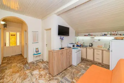 a large kitchen with a tv on the wall at Apartment Carpe Diem with the best sea view, Utjeha Montenegro Mediterranean Eu in Masline