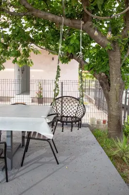 a ping pong table and a swing under a tree at TWINS DREAMs HOUSE in Bar