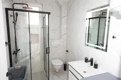 a bathroom with a shower and a toilet and a sink at TWINS DREAMs HOUSE in Bar