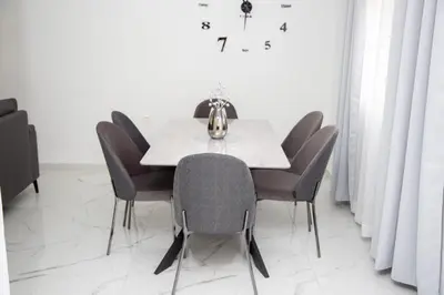 a dining room with a white table and chairs at TWINS DREAMs HOUSE in Bar
