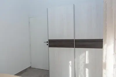 a white closet with a door in a room at TWINS DREAMs HOUSE in Bar