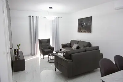 a living room with a couch and two chairs at TWINS DREAMs HOUSE in Bar