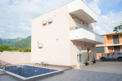 a white building with a swimming pool on a patio at TWINS DREAMs HOUSE in Bar