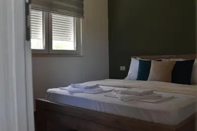 a bedroom with a bed with towels on it at KenDar Premium Apartments in Ulcinj