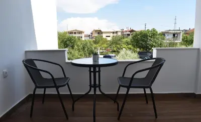 a small table and two chairs on a balcony at KenDar Premium Apartments in Ulcinj