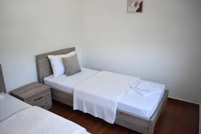 a hotel room with two beds with white sheets at KenDar Premium Apartments in Ulcinj