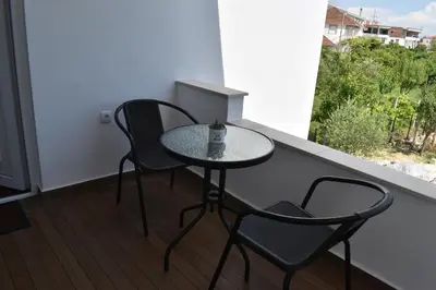 a small table and two chairs on a balcony at KenDar Premium Apartments in Ulcinj