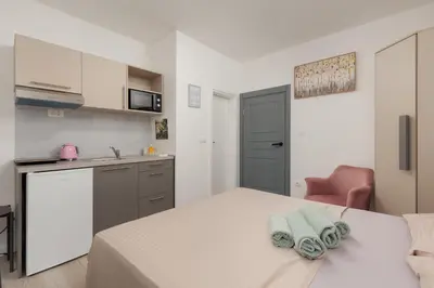 a room with a bed with towels on it at Apartments TIME in Kotor
