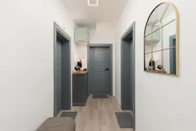 a hallway with two blue doors and a mirror at Apartments TIME in Kotor