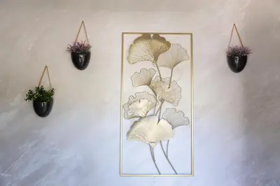 a wall with two potted plants and a mirror at Apartments TIME in Kotor