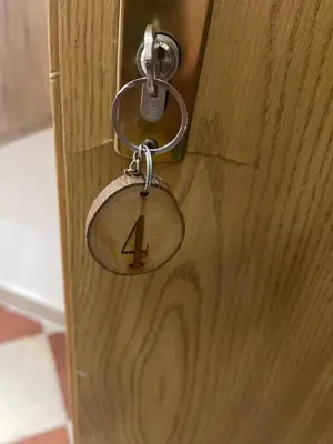 a key chain attached to a wooden door at Kodra Apartments in Ulcinj