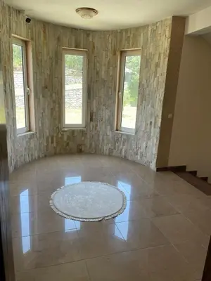 an empty room with a rug on a tiled floor at Kodra Apartments in Ulcinj