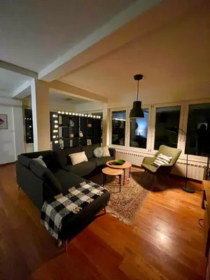 a living room with a couch and a table at Sunny apartments in Budva