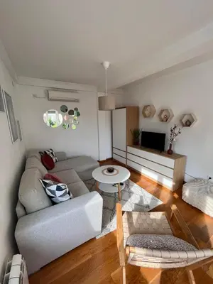 a living room with a couch and a table at Sunny apartments in Budva