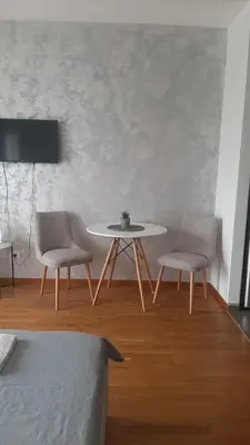 a dining room with a table and two chairs at Apartman City kvart pg in Podgorica