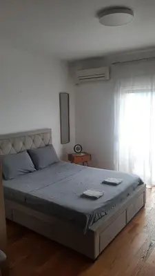 a large bed in a bedroom with a window at Apartman City kvart pg in Podgorica