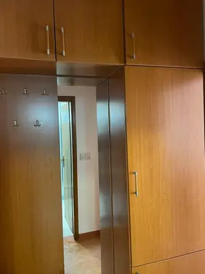 a room with wooden cabinets and a hallway at Dado Budva Apartment in Budva