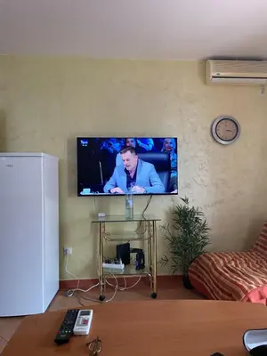 a flat screen tv on a wall in a living room at Dado Budva Apartment in Budva