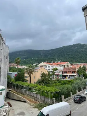 a city with cars parked in a parking lot at Dado Budva Apartment in Budva