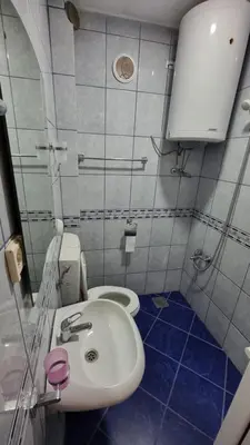 a bathroom with a white sink and a toilet at Apartmani Boskovic in Sutomore