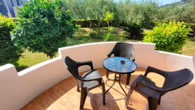 a group of chairs and a table on a balcony at Lula Apartments in Ulcinj
