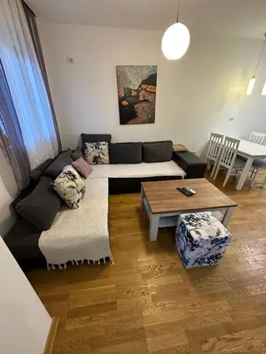 a living room with a couch and a table at Emina apartment City kvart in Kruševac