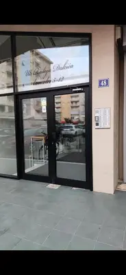 a store front with glass doors on a building at Emina apartment City kvart in Kruševac