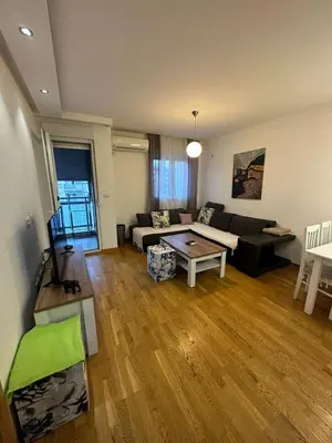 a living room with a couch and a table at Emina apartment City kvart in Kruševac