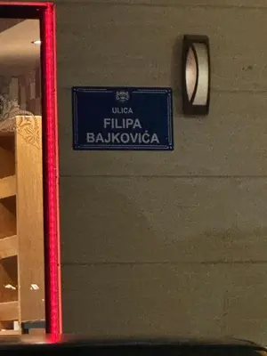 a blue sign on the side of a building at Emina apartment City kvart in Kruševac
