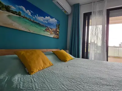 a bedroom with a bed with two yellow pillows at Studio-apartman Aroma in Bar