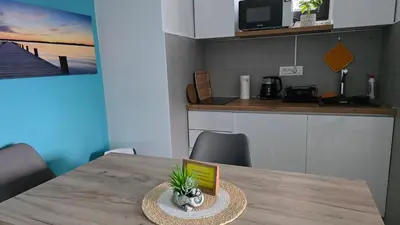 a table in a kitchen with a book on it at Studio-apartman Aroma in Bar