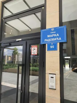 a blue sign on the side of a building at Sabina apartment City kvart in Podgorica