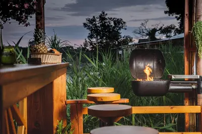 a patio with a fire pit on a deck at Bamboo River House in Ulcinj