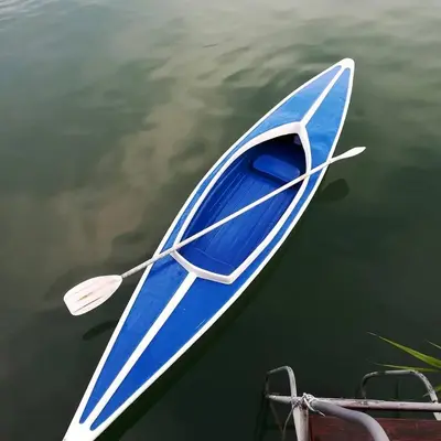 a blue and white boat sitting in the water at Bamboo River House in Ulcinj