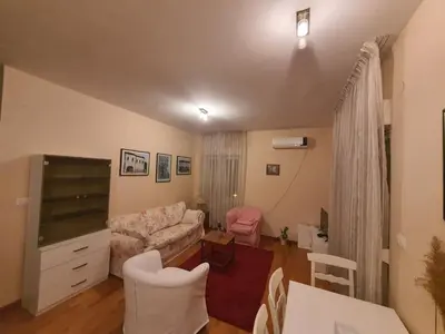 a living room with a couch and a table at Ana apartment City kvart in Podgorica