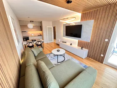 a living room with a couch and a table at APART 28- Luxury suites in Podgorica