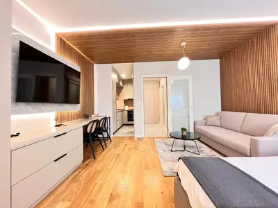 a bedroom with a bed and a living room at APART 28- Luxury suites in Podgorica