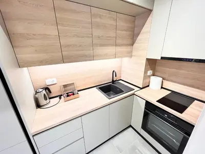 a small kitchen with a sink and a stove at APART 28- Luxury suites in Podgorica