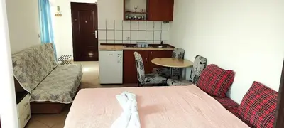 a kitchen with a table and chairs in a room at Villa Happy Family in Seoca