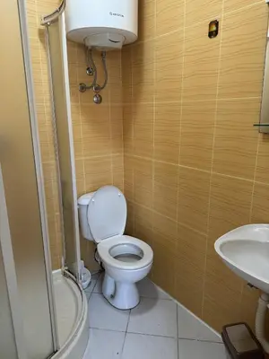 a bathroom with a toilet and a sink at Villa Happy Family in Seoca