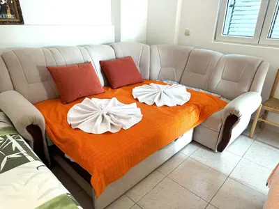 a couch with two pillows on top of it at Villa Happy Family in Seoca