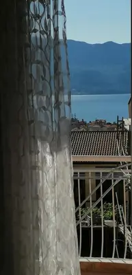 a curtain on a balcony with a view of the ocean at Marko Apartmani in Budva